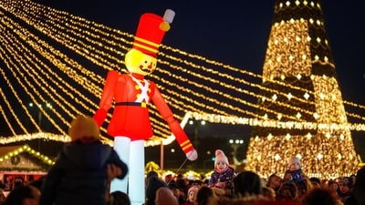 People visit a Christmas fair in Bucharest, Romania, Saturday. (AP) People visit a Christmas fair in Bucharest, Romania, Saturday. (AP)