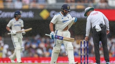 India's captain Rohit Sharma, center, and his batting partner KL Rahul leaves the field as rain stops play during play on day three of the third cricket test between India and Australia at the Gabba in Brisbane (AP) India's captain Rohit Sharma, center, and his batting partner KL Rahul leaves the field as rain stops play during play on day three of the third cricket test between India and Australia at the Gabba in Brisbane (AP)