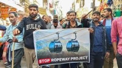 Hundreds of people on Sunday took out a rally through the main market in Katra, the base camp for pilgrims visiting Mata Vaishno Devi shrine in Reasi district of Jammu and Kashmir, chanting slogans against the shrine board for setting up a ropeway along the trek. (HT Photo)