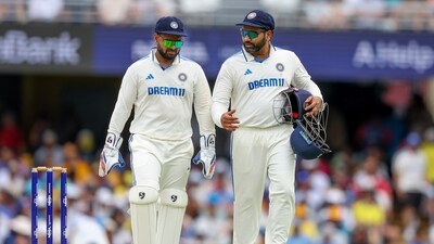 India's captain Rohit Sharma, right, talks to Rishabh Pant during play on day two of the third cricket test between India and Australia at the Gabba. (AP) India's captain Rohit Sharma, right, talks to Rishabh Pant during play on day two of the third cricket test between India and Australia at the Gabba. (AP)
