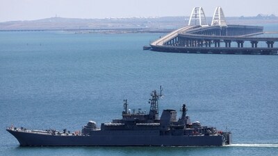 (Representational image) A Russian Navy amphibious landing ship that was deployed to transport cars across the Kerch Strait, moves near the Crimean Bridge, a section of which was damaged by an alleged overnight attack, as seen from the city of Kerch, Crimea. (REUTERS)