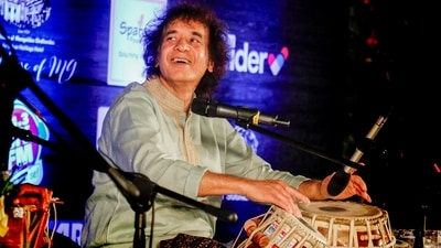 Ustad Zakir Hussain performed during the 100th birth anniversary of his father, Ustad Alla Rakha, in Ahmedabad. (PTI) Ustad Zakir Hussain performed during the 100th birth anniversary of his father, Ustad Alla Rakha, in Ahmedabad. (PTI)