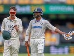 India's Ravindra Jadeja, right, and Australia's Travis Head walk off the field for lunch during play on day four of the third Test