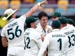 Australia's Pat Cummins celebrates after taking a wicket with teammates  Jono Searle/AAP Image via REUTERS  