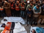 Mourners pray in front of the body of Al Jazeera journalist Ahmad Baker Al-Louh (R) and members of the Civil Defence, who were killed in an Israeli strike the day before, during their funeral in Nuseirat Mourners pray in front of the body of Al Jazeera journalist Ahmad Baker Al-Louh (R) and members of the Civil Defence, who were killed in an Israeli strike the day before, during their funeral in Nuseirat