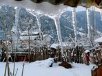 An area surrounding houses is covered in snow as Gurez Valley receives snowfall, in Bandipora on Sunday. An area surrounding houses is covered in snow as Gurez Valley receives snowfall, in Bandipora on Sunday.