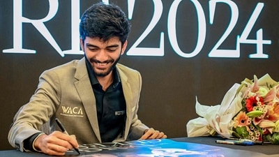 World chess champion Gukesh Dommaraju signs an autograph during a meet and greet session in Singapore after becoming world chess champion. (AFP) World chess champion Gukesh Dommaraju signs an autograph during a meet and greet session in Singapore after becoming world chess champion. (AFP)