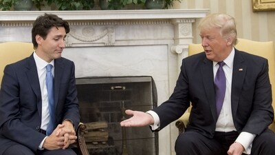 (FILES) US President Donald Trump and Canadian Prime Minister Justin Trudeau shake hands during a meeting in the Oval Office of the White House in Washington, DC, on February 13, 2017. The political circumstances that surrounded the publication of "Ultimatum," once a best-selling novel that imagined an American effort to annex Canada, may ring familiar to anyone following recent headlines. "Ultimatum," published in 1973, is authored by D-Day veteran Richard Rohmer, the honorary lieutenant general of the Canadian Armed Forces, who recently turned 101. Still an avid news consumer and writer, Rohmer told AFP that remarks by President-elect Donald Trump implying that Canada could be absorbed by the United States should not be laughed off. (Photo by SAUL LOEB / AFP) (AFP) (FILES) US President Donald Trump and Canadian Prime Minister Justin Trudeau shake hands during a meeting in the Oval Office of the White House in Washington, DC, on February 13, 2017. The political circumstances that surrounded the publication of "Ultimatum," once a best-selling novel that imagined an American effort to annex Canada, may ring familiar to anyone following recent headlines. "Ultimatum," published in 1973, is authored by D-Day veteran Richard Rohmer, the honorary lieutenant general of the Canadian Armed Forces, who recently turned 101. Still an avid news consumer and writer, Rohmer told AFP that remarks by President-elect Donald Trump implying that Canada could be absorbed by the United States should not be laughed off. (Photo by SAUL LOEB / AFP) (AFP)