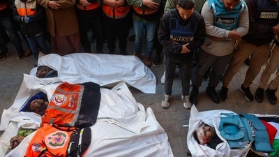Mourners pray in front of the body of Al Jazeera journalist Ahmad Baker Al-Louh (R) and members of the Civil Defence, who were killed in an Israeli strike the day before, during their funeral in Nuseirat (AFP) Mourners pray in front of the body of Al Jazeera journalist Ahmad Baker Al-Louh (R) and members of the Civil Defence, who were killed in an Israeli strike the day before, during their funeral in Nuseirat (AFP)