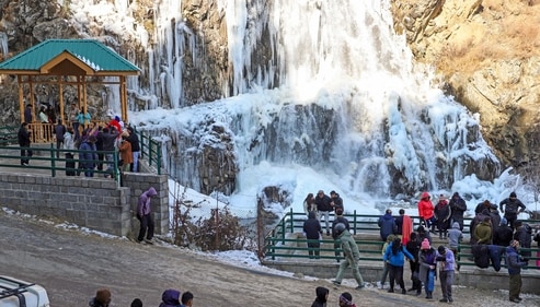 Tourists visit a frozen waterfall at Drung area on a cold winter morning, in Baramulla district, Jammu and Kashmir, (PTI) Tourists visit a frozen waterfall at Drung area on a cold winter morning, in Baramulla district, Jammu and Kashmir, (PTI)