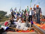 Farmers block railway tracks as part of their state-wide 'Rail Roko' protest to press the Centre into accepting their various demands, including a legally binding minimum support price for crops, on the outskirts of Amritsar, Wednesday, Dec. 18, 2024. 