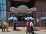 People walk past the Bombay Stock Exchange (BSE) building, in Mumbai, Thursday, Oct. 3, 2024. 