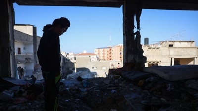 People inspect the damage following Israeli strikes on the Ahmad Abdulaziz UNRWA-run school currently housing displaced families in Khan Yunis in the southern Gaza Strip on December 16, 2024, amid the ongoing war between Israel and the Palestinian Hamas movement. (AFP) People inspect the damage following Israeli strikes on the Ahmad Abdulaziz UNRWA-run school currently housing displaced families in Khan Yunis in the southern Gaza Strip on December 16, 2024, amid the ongoing war between Israel and the Palestinian Hamas movement. (AFP)