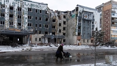 A woman walks past a building damaged by a Russian military strike, amid Russia's attack on Ukraine, in the town of Pokrovsk in Donetsk region, Ukraine December 12, 2024. (REUTERS)