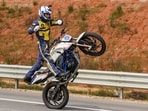 Sumit Tomar, a member of the Army Service Corps (ASC) 'Tornadoes' of the Indian Army, rides a motorcycle in an attempt to break the world record for the 'longest no-hands motorcycle wheelie', in Bengaluru, Karnataka.
