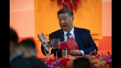Chinese President Xi Jinping gestures as he talks to leaders during a welcoming dinner, ahead of celebrations for the 25th anniversary of Macao's handover from Portugal to China, in Macao, Thursday, Dec. 19, 2024. (AP Photo/Anthony Kwan, Pool) (AP)