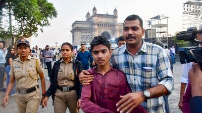 A passenger, in maroon shirt, after being rescued in a joint operation by the Indian Navy and Indian Coast Guard after a ferry capsized off Mumbai coast. (PTI) A passenger, in maroon shirt, after being rescued in a joint operation by the Indian Navy and Indian Coast Guard after a ferry capsized off Mumbai coast. (PTI)