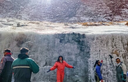 Tourists near at waterfall which has turned into ice amidst the continuous drop in temperature, in Lahaul-Spiti district of Himachal Pradesh, Saturday, Dec. 14, 2024. (PTI) Tourists near at waterfall which has turned into ice amidst the continuous drop in temperature, in Lahaul-Spiti district of Himachal Pradesh, Saturday, Dec. 14, 2024. (PTI)