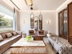 Warm tones of teak and walnut complement Mocha Mousse beautifully, adding both texture and warmth to the space. Photo: Courtesy Harkaran Boparai Studio (HBS).