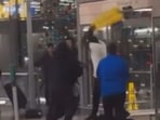 A brawl at Chicago O'Hare Airport saw people fighting with wet-floor signs.