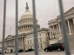 The dome of the Capitol is seen through a security fence on a day where a potential government shutdown looms during the holidays after a spending bill backed by Donald Trump failed in the US House of Representatives, on Capitol Hill in Washington, US. 