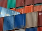 FILE PHOTO: A worker sits on a ship carrying containers at Mundra Port in the western Indian state of Gujarat April 1, 2014. REUTERS/Amit Dave/File Photo