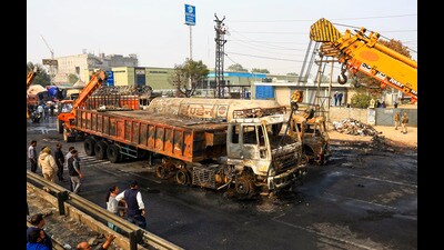 Cranes move the charred truck from the site of the accident on the Jaipur-Ajmer Highway on Friday. (PTI)