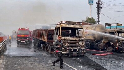 Firefighters extinguish the fire at the site of the accident after a truck loaded with a chemical collided with some other vehicles. (PTI) Firefighters extinguish the fire at the site of the accident after a truck loaded with a chemical collided with some other vehicles. (PTI)