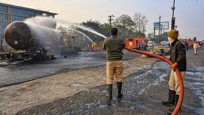 Firefighters douse the fire at the site of the accident. (PTI) Firefighters douse the fire at the site of the accident. (PTI)