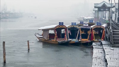 Shikaras are anchored as a thin sheet of ice forms on the surface of the Dal Lake as temperature dips further in Srinagar on Friday. (ANI) Shikaras are anchored as a thin sheet of ice forms on the surface of the Dal Lake as temperature dips further in Srinagar on Friday. (ANI)
