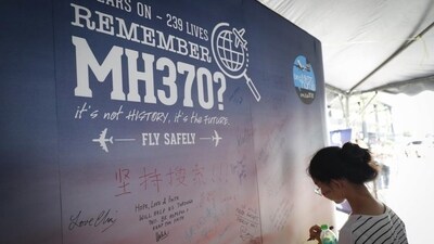 A girl writes a condolence message during the Day of Remembrance for MH370 event in Kuala Lumpur, Malaysia. (AP Photo) A girl writes a condolence message during the Day of Remembrance for MH370 event in Kuala Lumpur, Malaysia. (AP Photo)