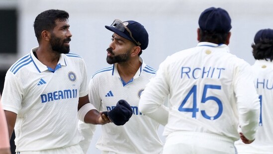 India's Virat Kohli (C) greets Jasprit Bumrah (2nd L) for his wicket of Australia's Usman Khawaja on day two of the third cricket Test (AFP)