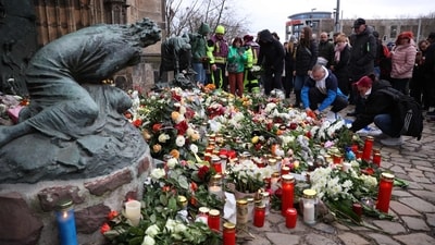 Germany Christmas market attack: People lay flowers and candles at the site of a car-ramming attack on a Christmas market in Magdeburg, eastern Germany, on December 21, 2024, resulting in several deaths and dozens of injured. (Photo by Ronny HARTMANN / AFP) (AFP) Germany Christmas market attack: People lay flowers and candles at the site of a car-ramming attack on a Christmas market in Magdeburg, eastern Germany, on December 21, 2024, resulting in several deaths and dozens of injured. (Photo by Ronny HARTMANN / AFP) (AFP)