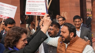 Congress MP Priyanka Gandhi Vadra and BJP MP Hemang Joshi with other INDIA bloc and NDA members during a protest in Parliament premises, in New Delhi, Thursday, Dec. 19, 2024. (PTI) Congress MP Priyanka Gandhi Vadra and BJP MP Hemang Joshi with other INDIA bloc and NDA members during a protest in Parliament premises, in New Delhi, Thursday, Dec. 19, 2024. (PTI)