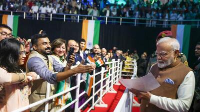 Prime Minister Narendra Modi signs autographs for the Indian diaspora during the community program 'Hala Modi', at Shaikh Saad Al Abdullah Indoor Sports Complex, in Sabah Al Salem on Saturday. (ANI) Prime Minister Narendra Modi signs autographs for the Indian diaspora during the community program 'Hala Modi', at Shaikh Saad Al Abdullah Indoor Sports Complex, in Sabah Al Salem on Saturday. (ANI)