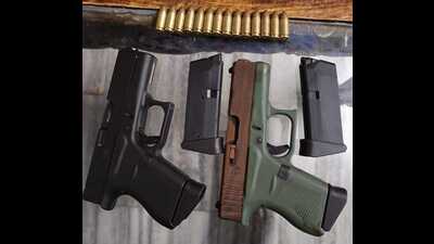 Two Glock pistols, four magazines and 14 cartridges were recovered from the accused in Pathankot. (HT Photo) Two Glock pistols, four magazines and 14 cartridges were recovered from the accused in Pathankot. (HT Photo)