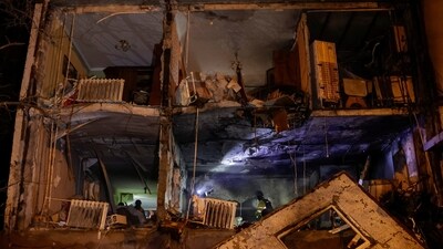 Rescuers work at a site of an apartment building damaged by Russian drone strike, amid Russia's attack on Ukraine, in Kharkiv. (REUTERS)
