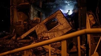A rescuer works at a site of an apartment building damaged by a Russian drone strike, amid Russia's attack on Ukraine, in Kharkiv. (REUTERS)