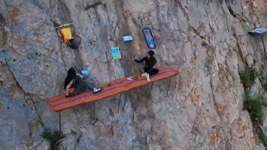 Coffee lovers in China braved cliffs for scenic brews, sparking awe and anxiety online. (Facebook/Holy Fujian)