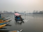 A boatman tries to break the ice sheet on Dal Lake’s surface in Srinagar on Saturday. A boatman tries to break the ice sheet on Dal Lake’s surface in Srinagar on Saturday.