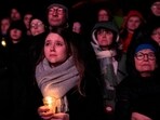People outside Magdeburg Cathedral follow a memorial service for victims of Friday's Christmas Market attack, where a car drove into a crowd, in Magdeburg, Germany, People outside Magdeburg Cathedral follow a memorial service for victims of Friday's Christmas Market attack, where a car drove into a crowd, in Magdeburg, Germany,