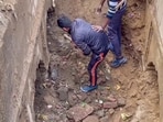 Workers during excavation work at a site at Chandausi area, in Sambhal.