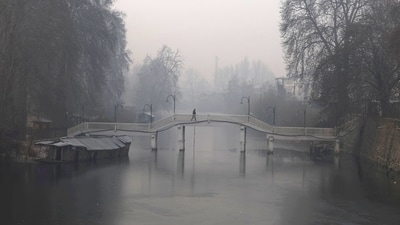 A man walks across a wooden bridge near the partially frozen stream which connects Dal Lake in Srinagar, (Waseem Andrabi /Hindustan Times) A man walks across a wooden bridge near the partially frozen stream which connects Dal Lake in Srinagar, (Waseem Andrabi /Hindustan Times)