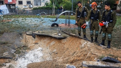 Israeli emergency services work at the scene of a missile strike that, according to Israel's military, was launched from Yemen and landed in Jaffa, south of Tel Aviv, Israel. (REUTERS)