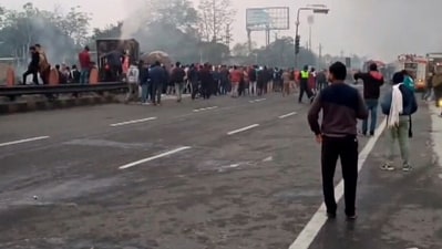 People gather near the site of a massive fire which broke out following a truck collision outside a petrol pump, in Jaipur, Friday morning. (PTI) People gather near the site of a massive fire which broke out following a truck collision outside a petrol pump, in Jaipur, Friday morning. (PTI)