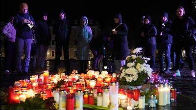 People light candles outside Magdeburg Cathedral after a memorial service for victims of Friday's Christmas Market attack (AP)