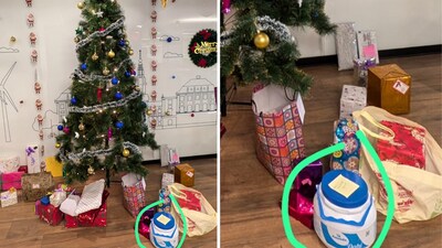 A blue and white tub of dahi with a yellow post-it note on it was placed under an office Christmas tree. (X/@ruag_rama) A blue and white tub of dahi with a yellow post-it note on it was placed under an office Christmas tree. (X/@ruag_rama)