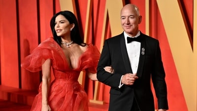 Lauren Sanchez and Jeff Bezos arrive at the Vanity Fair Oscar Party. (AP Photo)