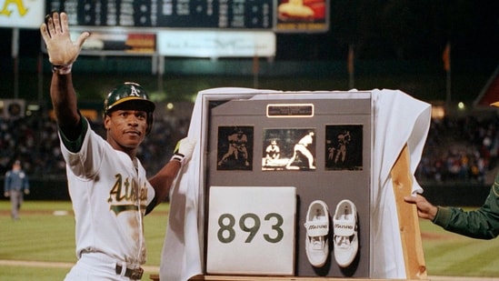 FILE - Rickey Henderson waves to the crowd during a presentation after he stole third base against the Toronto Blue Jays in the seventh inning to break Ty Cobb's career stolen base record, at Oakland Coliseum in Oakland, Calif., May 30, 1990. (AP Photo/Paul Sakuma, File) (AP)
