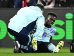 Arsenal's Bukayo Saka receives medical attention after sustaining an injury.